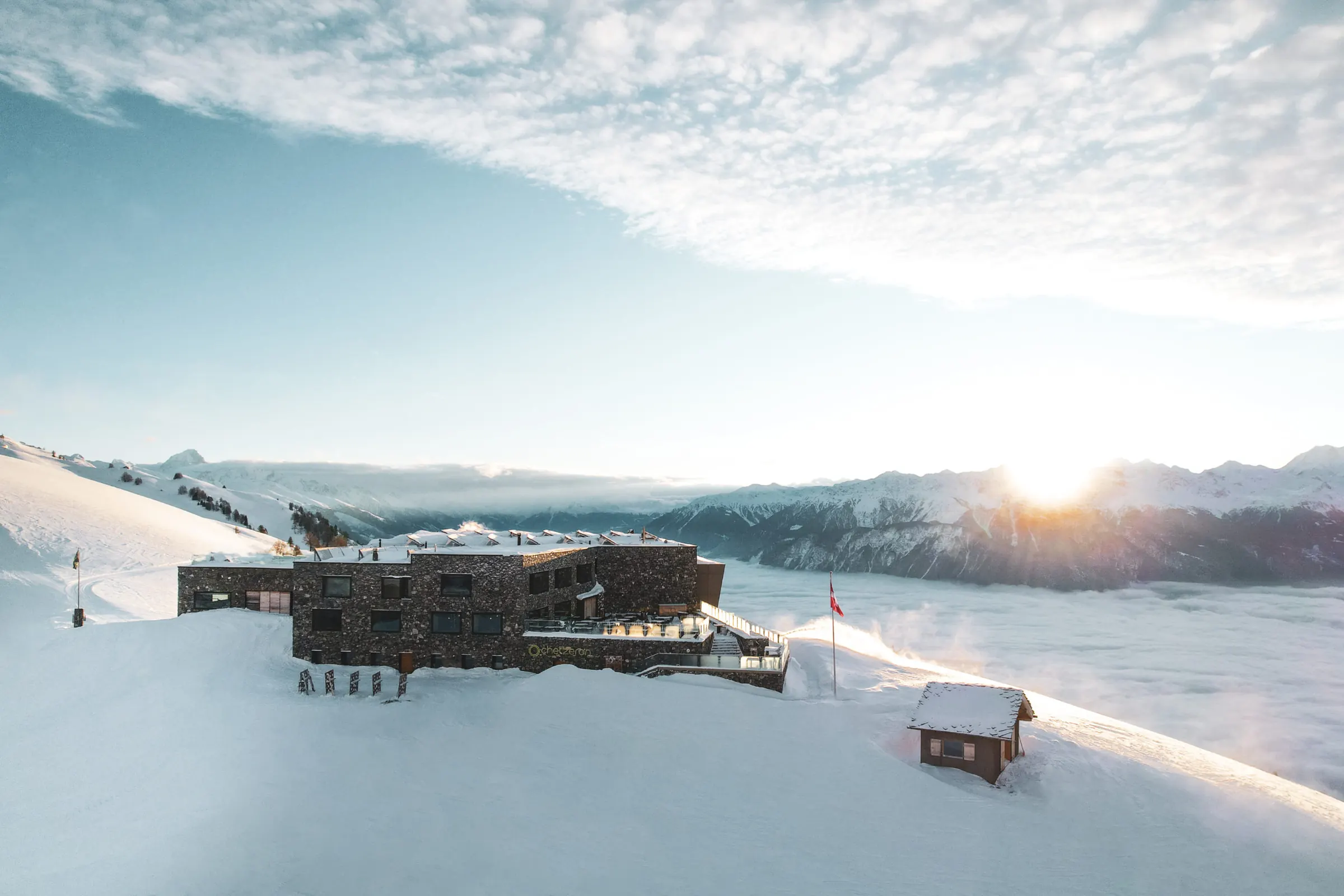 Chetzeron dans la neige au lever du soleil, au-dessus de la mer de brouillard